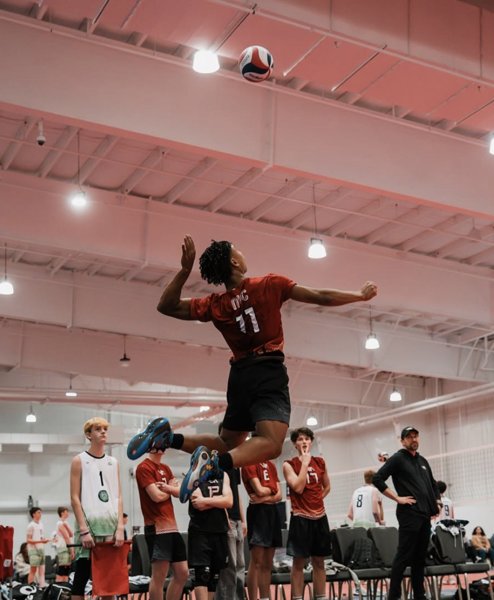 Volleyball player rising above the net for a spike